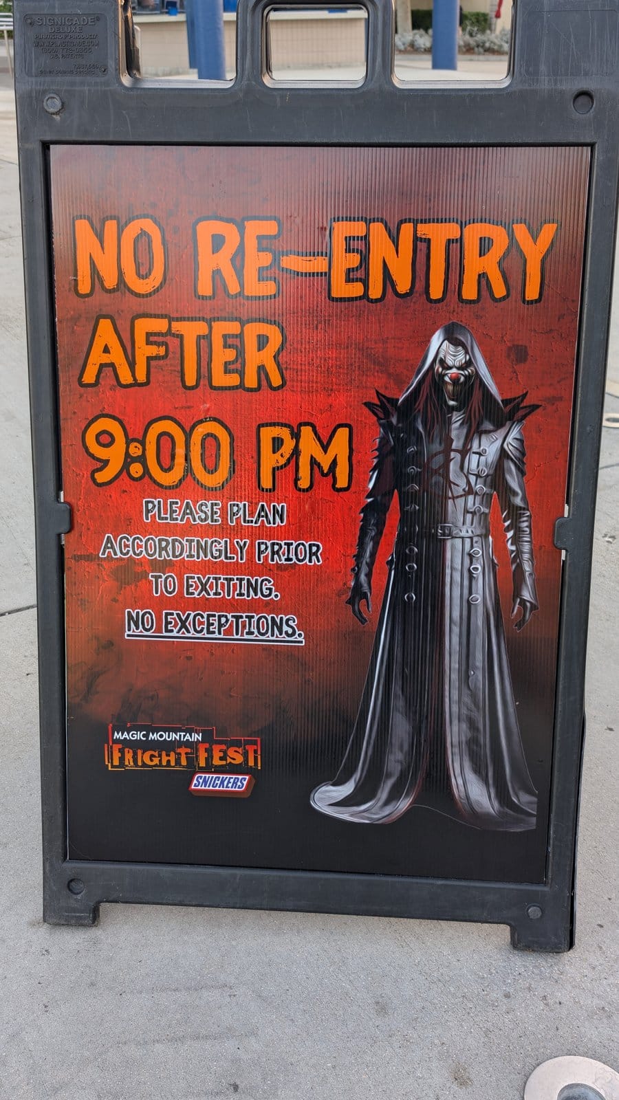 Fright Fest sign at Six Flags Magic Mountain reading No Re-Entry After 9:00 PM, with the Carnage character