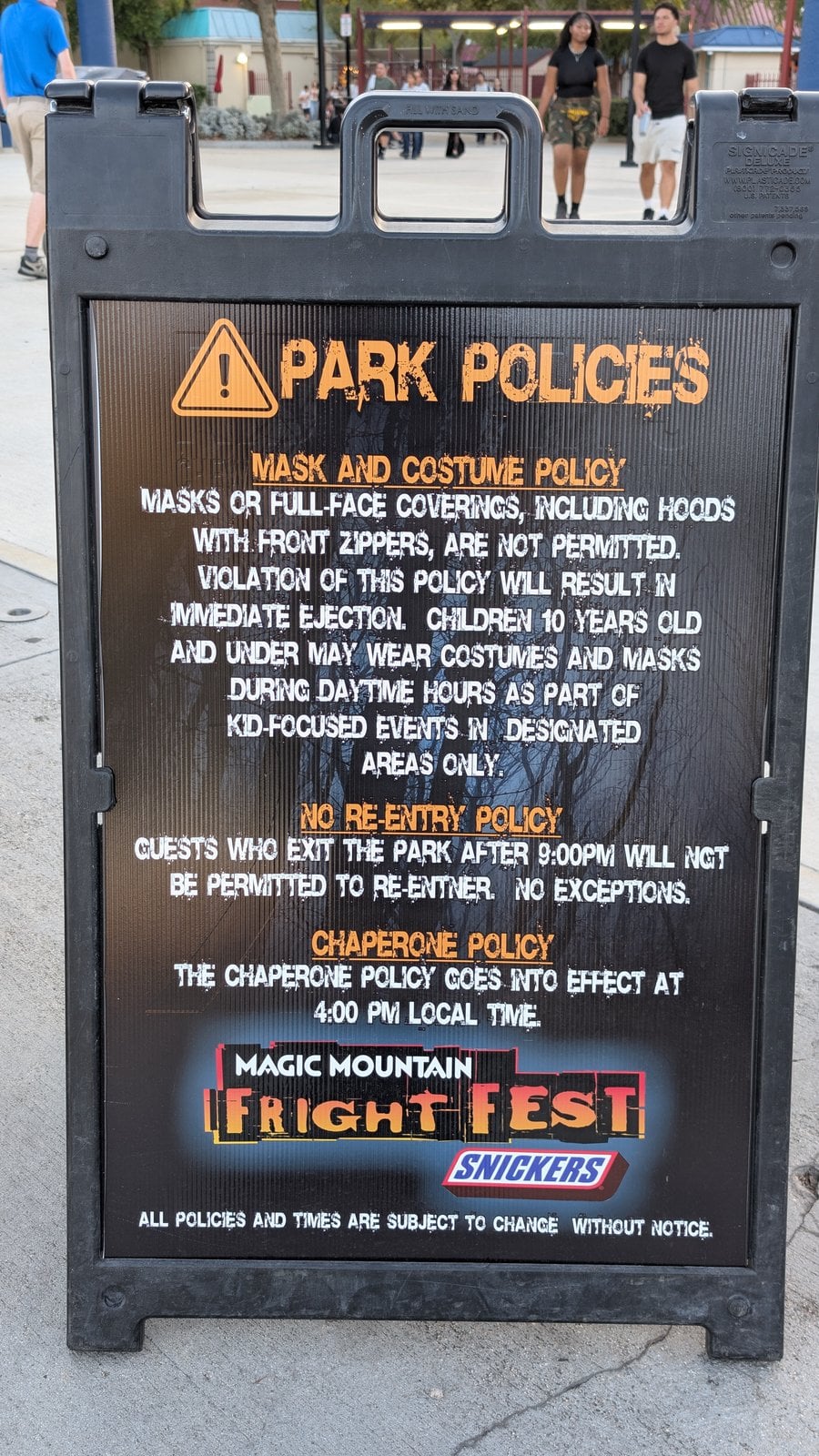 Fright Fest park policies sign at Six Flags Magic Mountain covering masks, no re-entry after 9 p.m., and the 4 p.m. chaperone policy