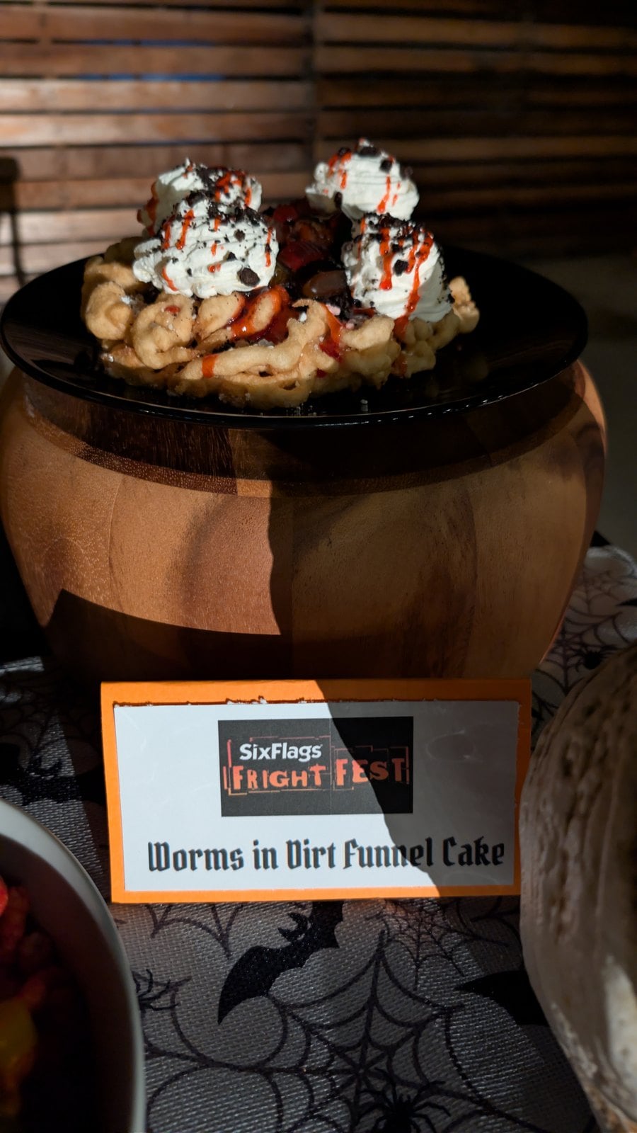 Worms in Dirt Funnel Cake with whipped cream, raspberry, Oreo crumbles, and gummy worms