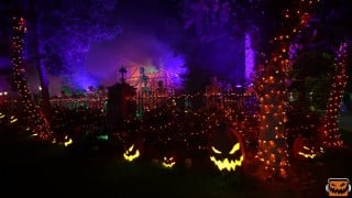 Jack-o'-lanterns and skeletons in a Southern California home haunt's graveyard on Halloween night
