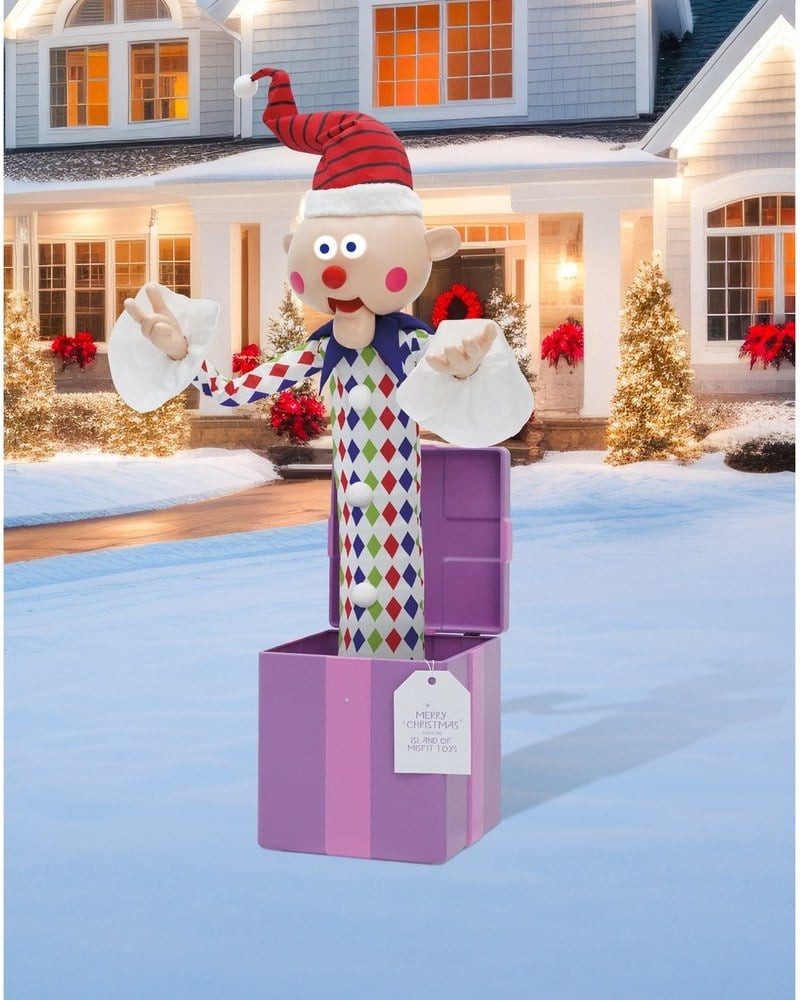 A Misfit Charlie-in-the-Box animatronic, a clown popping out of a purple box, on a snowy front lawn