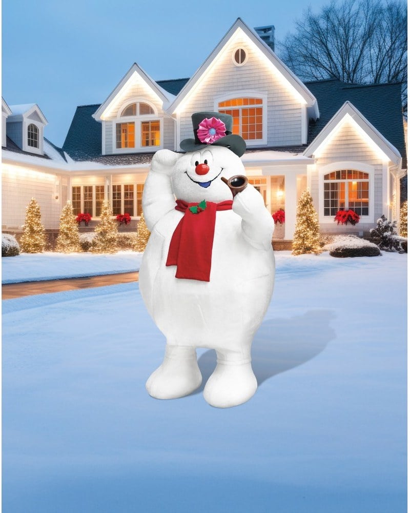 A Frosty the Snowman animatronic with a top hat and red scarf on a snowy lawn