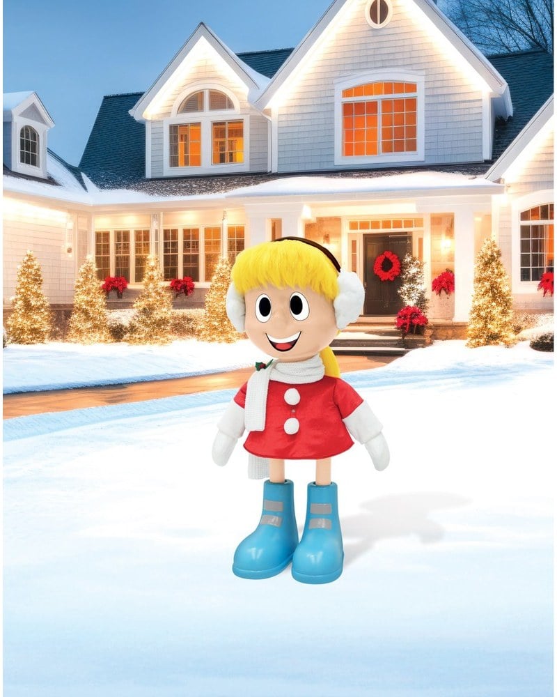 A Karen animatronic in a red coat and earmuffs on a snowy lawn