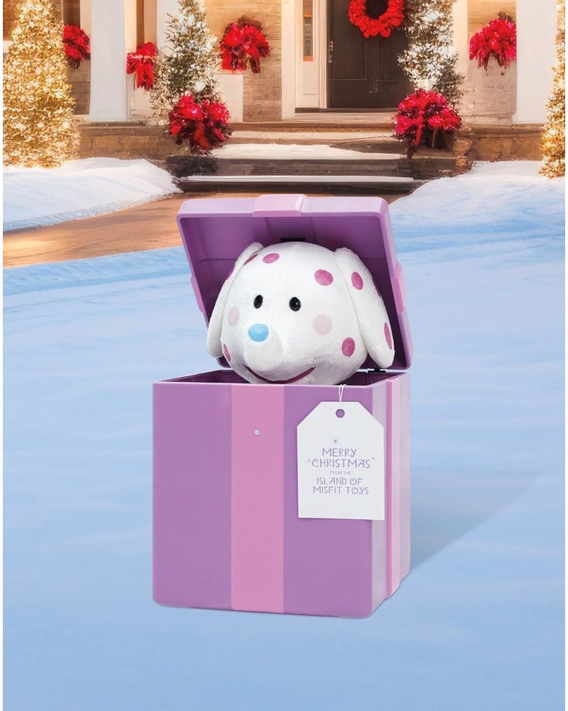 A spotted Misfit Elephant animatronic rising from a purple gift box
