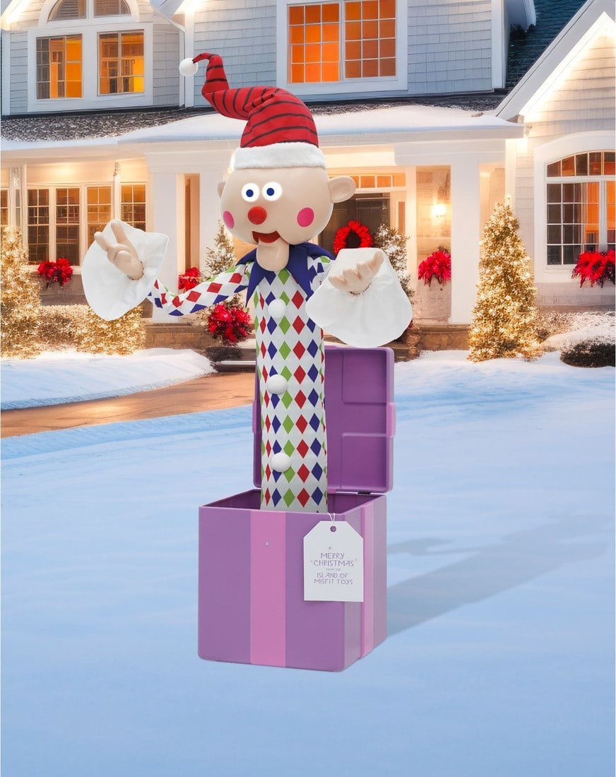 A Misfit Charlie-in-the-Box animatronic, a clown popping out of a purple box, on a snowy front lawn