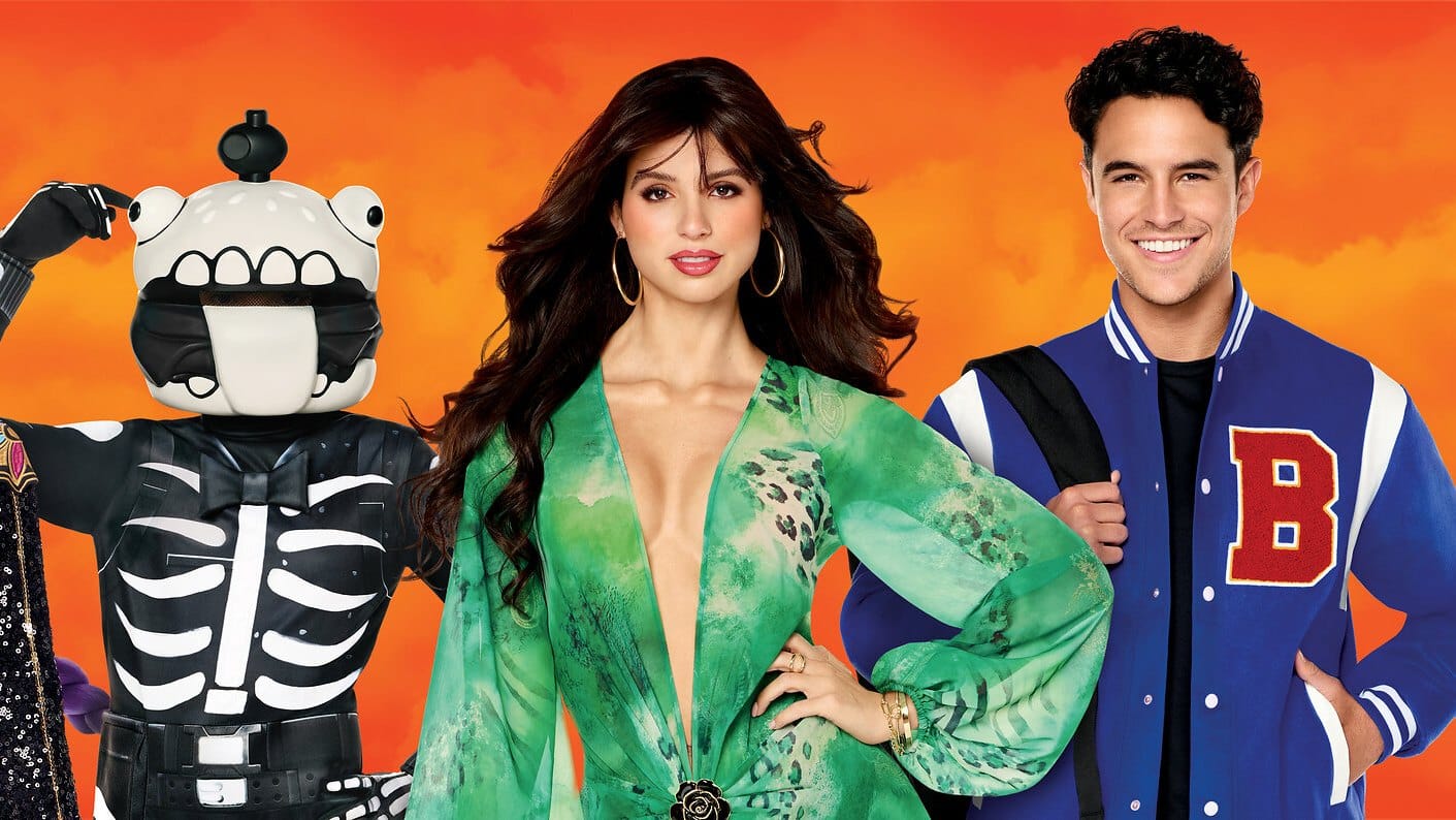 A character in a skeleton suit with a large cartoon head, a woman in a green jungle-print dress, and a man in a blue and white varsity jacket