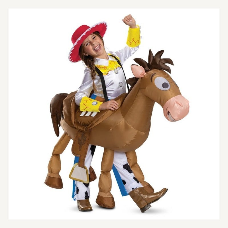 A child dressed as Jessie appears to ride an inflatable Bullseye horse costume