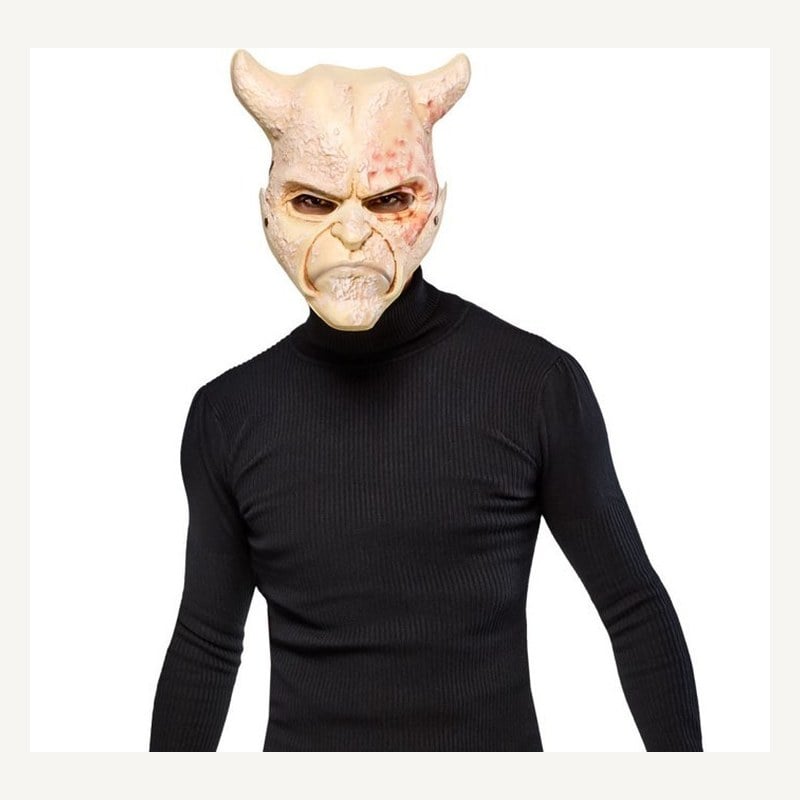 A man in a black turtleneck wearing a pale horned Grabber half mask