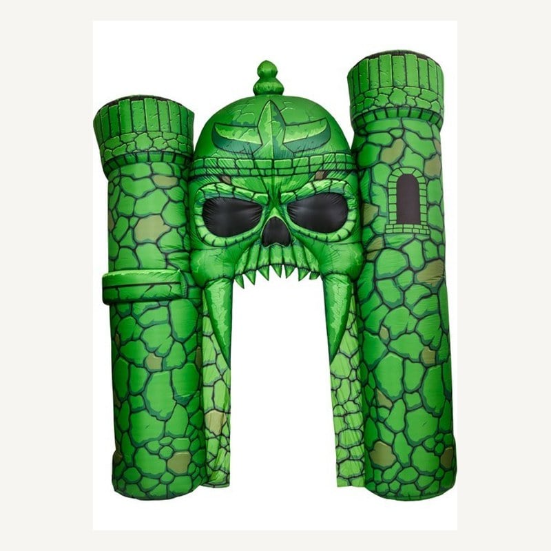 A green inflatable Castle Grayskull with its skull-faced gate