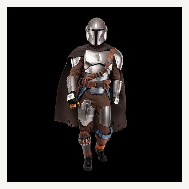 A man in a full Mandalorian costume with silver armor plating, a helmet, and a brown cape