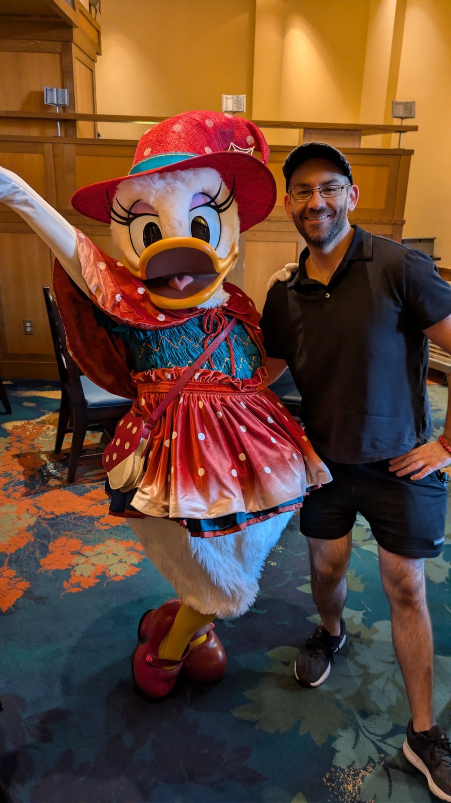 Daisy Duck in her fall outfit at Clarabelle's Enchanted Halloween Dinner, with Philip Hernandez