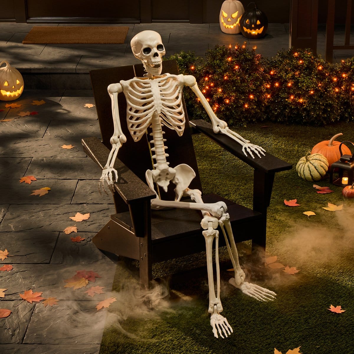 Target 60-inch Pose-N-Stay poseable skeleton in a black chair on a Halloween porch