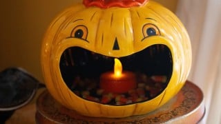 Johanna Parker Black Cat Jack Big Mouth Bowl, a mustard jack-o-lantern candy bowl filled with candy corn