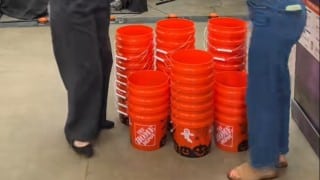 Home Depot Halloween print buckets with ghost and jack-o-lantern designs stacked in store