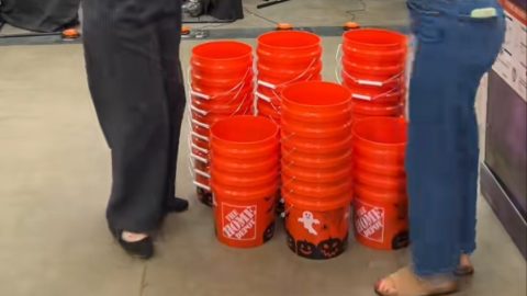 Home Depot Halloween print buckets with ghost and jack-o-lantern designs stacked in store