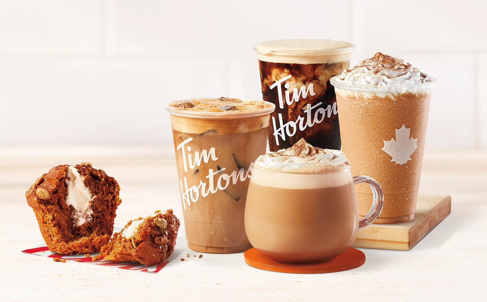 Tim Hortons Pumpkin Spice lineup: latte, iced latte, cold brew, Iced Capp, and a Pumpkin Spice Muffin