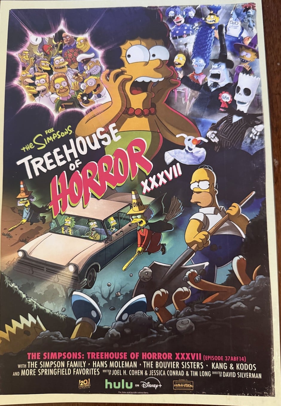The Treehouse of Horror XXXVII poster: Marge screaming, Patty and Selma as witches in DMV traffic-cone hats beside a car, and Homer holding a shovel over a grave