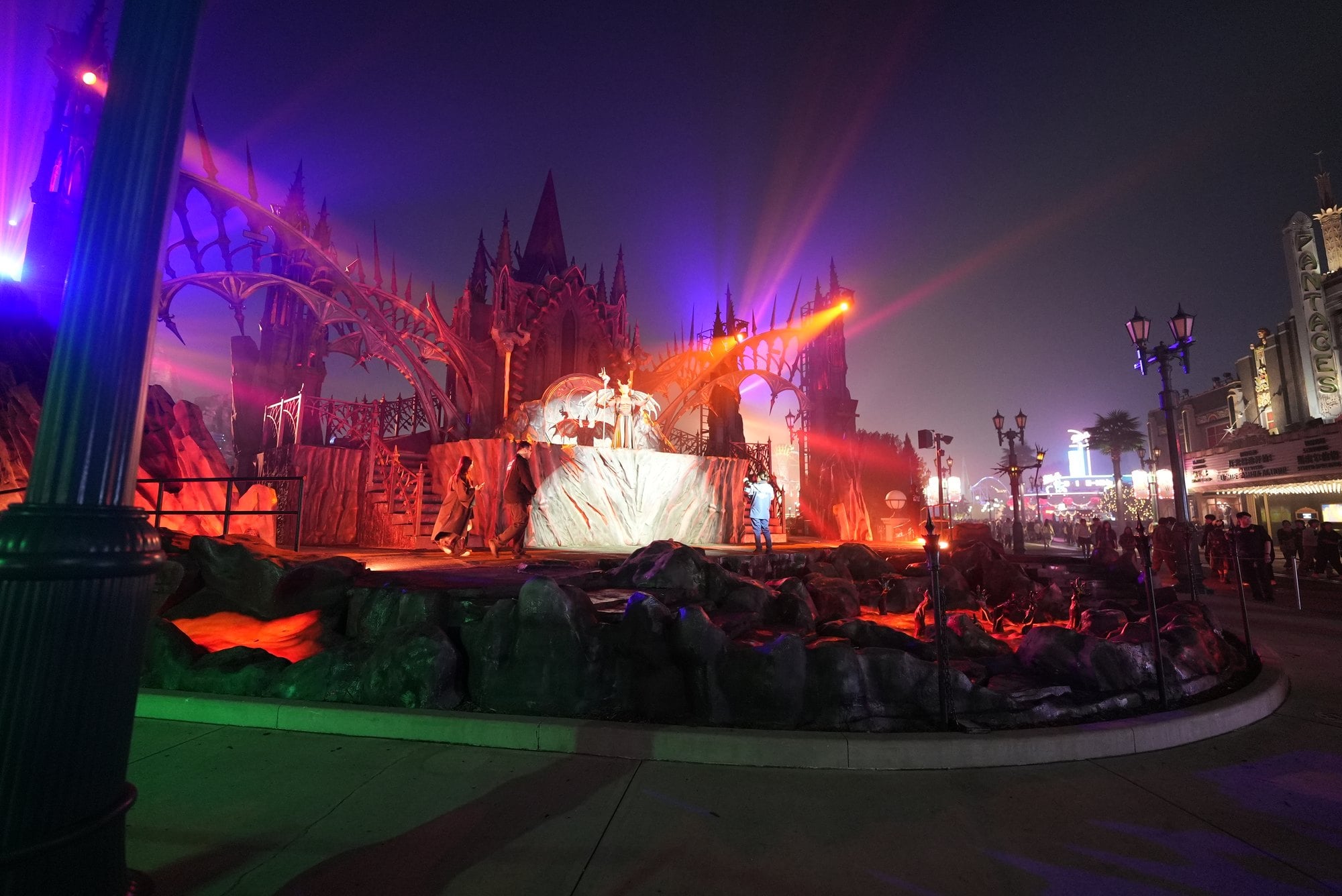 The castle stage at Universal Studios Beijing glows red and purple at night after the opening ceremony